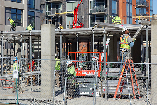 Construction workers working on a new apartment complex in the North Loop on Thursday.
