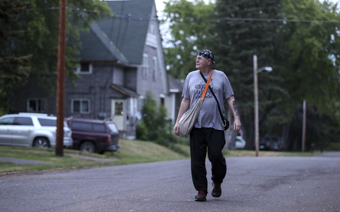 Dave Wittke walks to the next house along his route with a traditional newspaper carrier’s bag slung over his shoulder on Wednesday, June 24, in Gary-New Duluth. Wittke walks his portion of the route while his wife Tina drives to places farther away. (Tyler Schank / tschank@duluthnews.com)