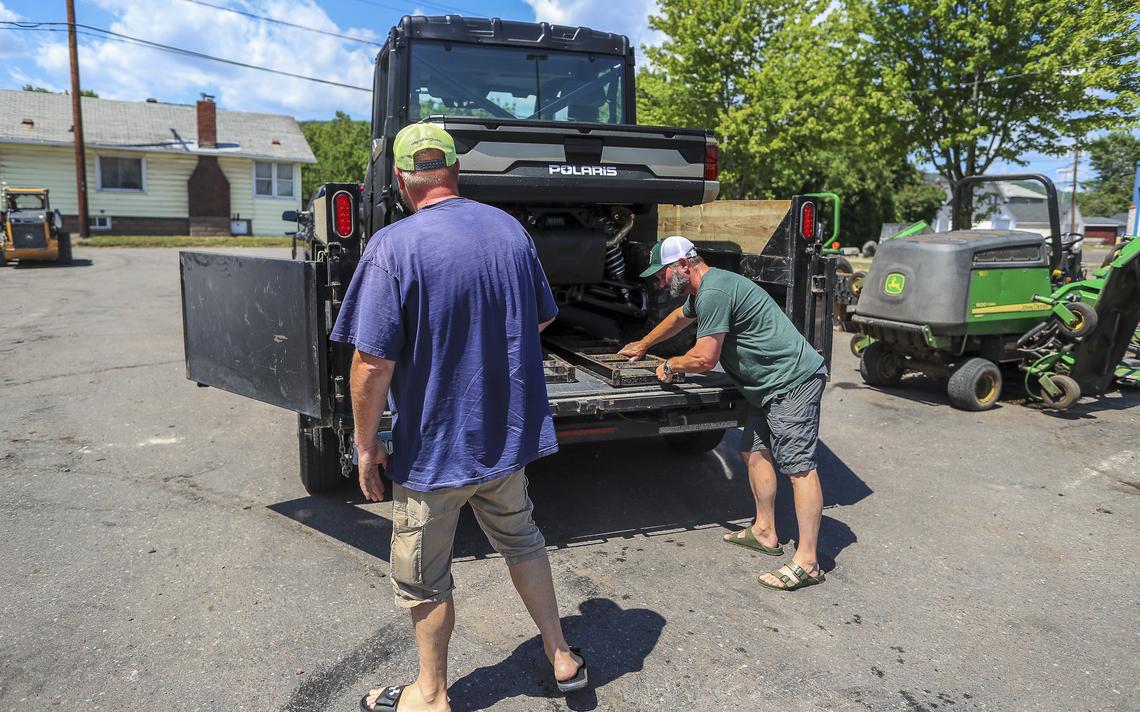 Jason MacDonald (left) and Jim DeArmond both of Duluth make sure DeArmond's new side-by-side ATV is secured to a trailer while picking up the vehicle Thursday at Duluth Lawn & Sport. (Clint Austin / caustin@duluthnews.com) 