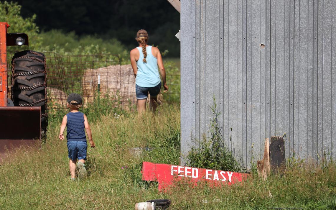 Hannah Bernhardt is followed by her son, Harvey, on Medicine Creek Farm in Finlayson, Minn. (Noah Fish / Agweek)