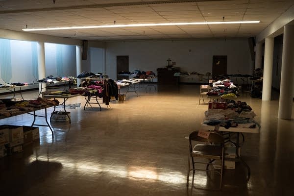 A room with tables of clothing.