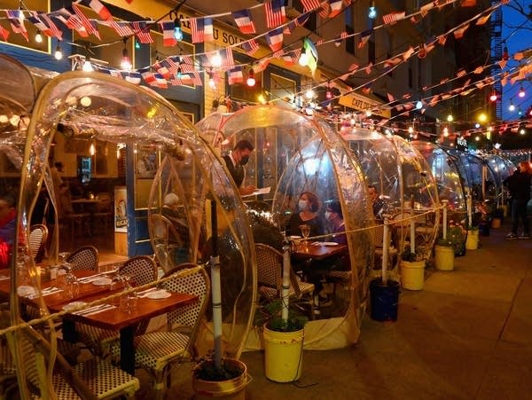 People dine in plastic "bubbles" for social distancing