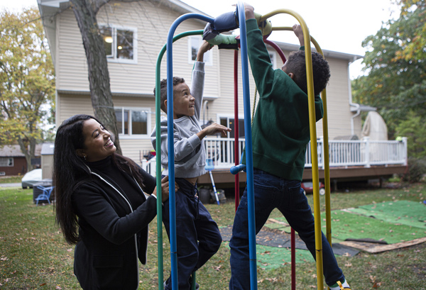 Mercedes and her two sons Lucas, 7, (center) and Sebastian, 5, (right) play in their backyard. Mercedes' husband is a guard at New York's Rikers Island jail. Her sons struggled with home schooling, so in late August, with some trepidation, she gave up her corporate job.
