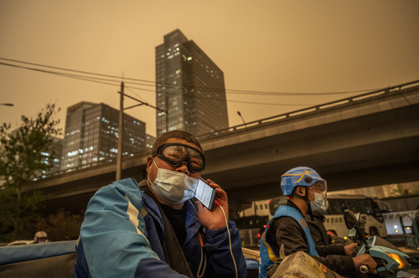 A courier wears a protective mask and goggles during a seasonal sandstorm on April 15 in Beijing.