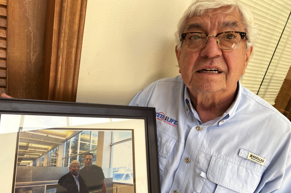 Former mayor Tony Martinez holds a photo of himself and Elon Musk, who he says has put  Brownsville on the map.