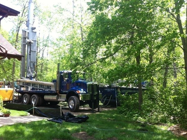 a well drilling truck in a yard