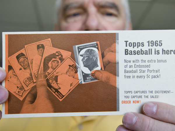 Collector and Taylor's Baseball Cards and Collectables store owner Ian Taylor, displays a very rare 1965 Topps promotional sample sheet.