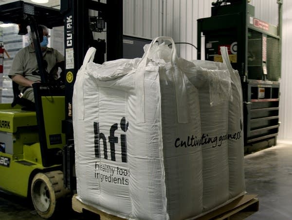 large bags are carried by a forklift 