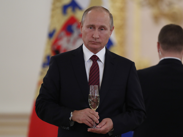 Russian President Vladimir Putin holds a glass of Soviet Champagne during a Kremlin ceremony in 2017. A new Russian law says only Russian sparkling wine may be sold in Russia as "champagne."