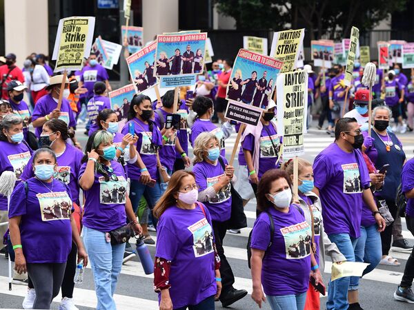 More than 1,000 janitors with the Service Employees International Union rally and march as their contracts expire ahead of a potential strike on Sept. 1, 2021, in Los Angeles.