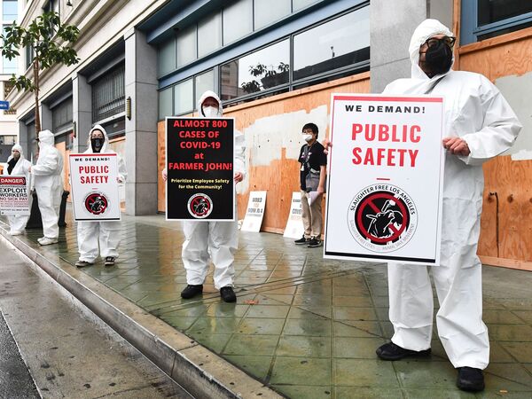 Animal rights activists protest in front of the Occupational Safety and Health Administration building in Los Angeles, Calif., on March 12, 2021, calling on OSHA to do more to protect slaughterhouse workers from COVID-19.