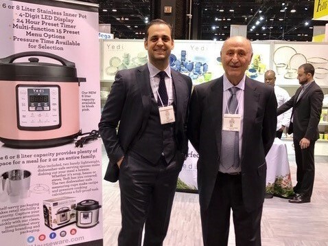 Bobby Djavaheri, president of Yeti Houseware Appliances, poses with his father, Yedidia, at the Chicago Houseware Show. Shipping delays have jeopardized a Black Friday promotion in which they hoped to sell more than $1 million worth of air fryers.