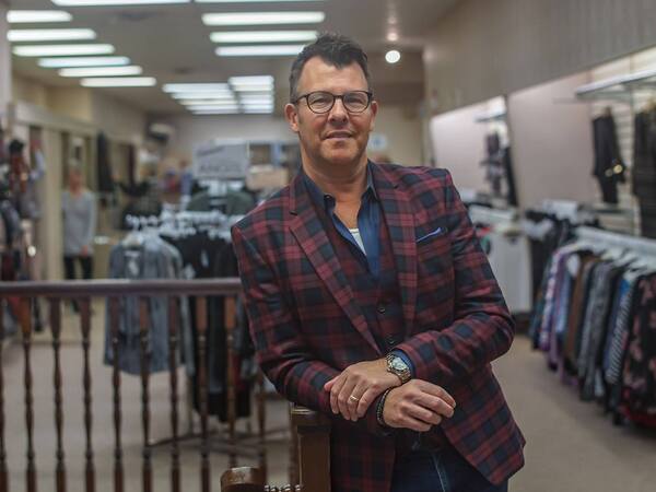 Danny Reynolds in his clothing store, Stephenson's, in Elkhart, Indiana. Reynolds is well stocked for Christmas, despite erratic deliveries this year.