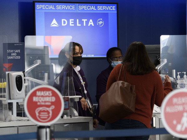 Passengers check bags for a Delta Air Lines, Inc. flight during the COVID-19 pandemic at Los Angeles International Airport.