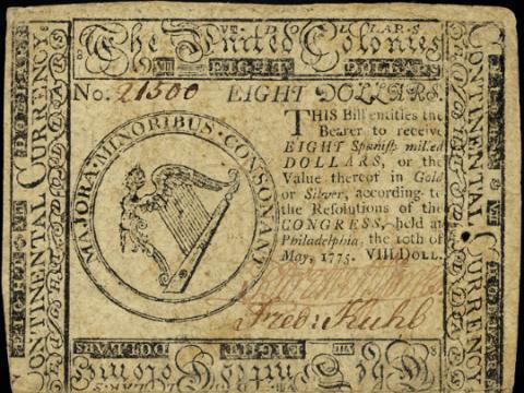 Image of an $8 Continental Currency paper note issued by the Continental Congress to finance the Revolutionary War, or the American Revolution. After gaining independence the U.S. adopted the dollar as its national currency.