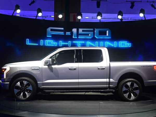 Ford's all-electric F-150 Lightning is displayed at the Los Angeles Auto Show on Nov. 18. Automakers are unveiling electric models of their most popular cars as they seek to take advantage of rising interest in electric vehicles.