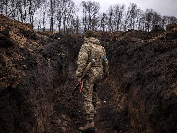 A Ukrainian serviceman walks in a trench at the front line east of Kharkiv, Ukraine, on March 31.