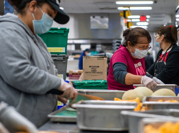Community volunteers cut and prepare fruit at the Houston Food Bank on Feb. 8.