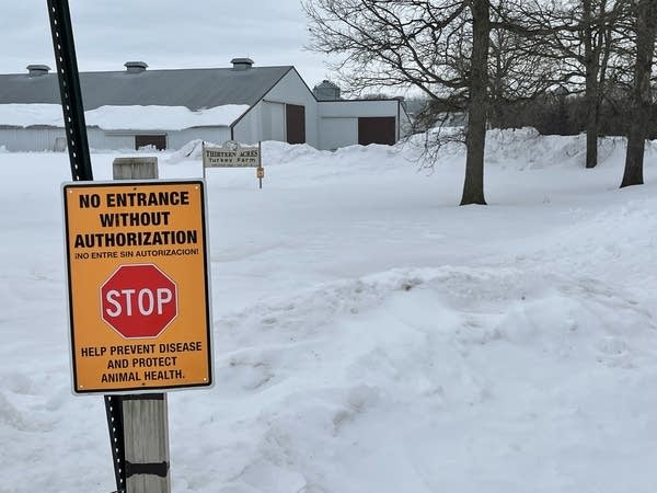 Signs warn unauthorized visitors not to enter a farm.