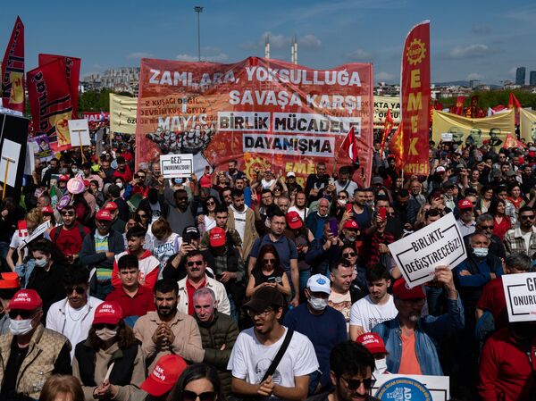 Demonstrators hold flags, banners and shout slogans during the annual May Day demonstration in the Maltepe district of Istanbul on Sunday.