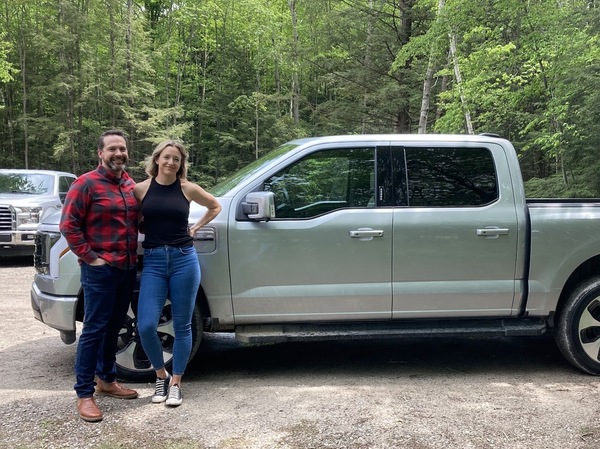 Schmidt and his wife pose with their new F-150 Lightning.