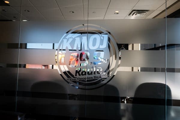 A logo that reads KMOJ on a window