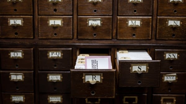 A card catalog with two drawers open