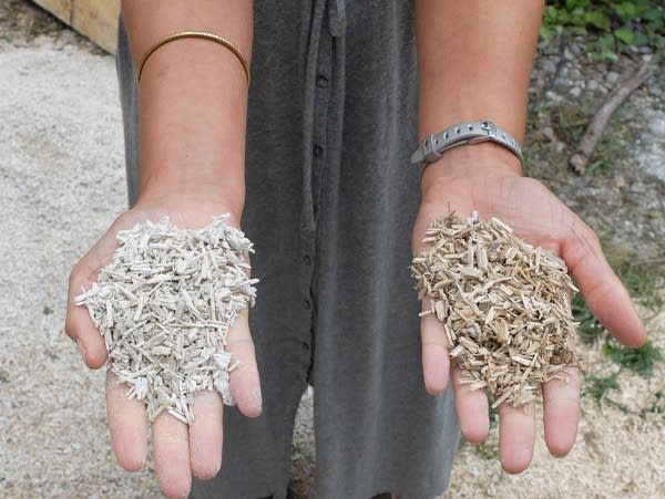 two hands hold chopped plant fibers 