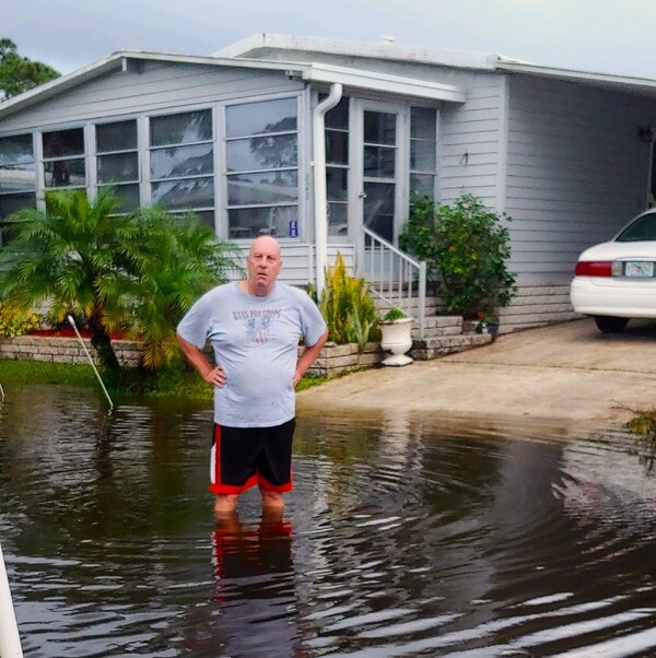 Mike Noel wading in flooding. "I should have been advised of this before I bought this home," Noel wrote in an email to the park manager. "This is ridiculous."
