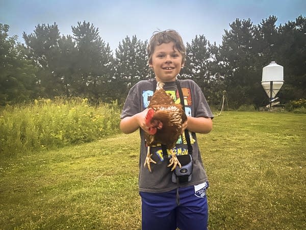 Isaac Yaeger holds a chicken