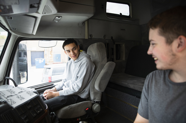 Seniors Peter Vilas Novas and Joshua Hewitt chat in the cab of the truck they're learning on. Both think they'd like to get into long-haul trucking once they earn their commercial driver licenses.