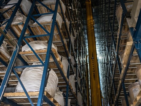 Pallet racks are stacked from floor to ceiling in a warehouse