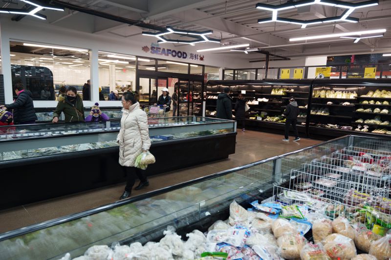 Large frozen item areas and shoppers milling around the shelves at Asian Mart 88. 