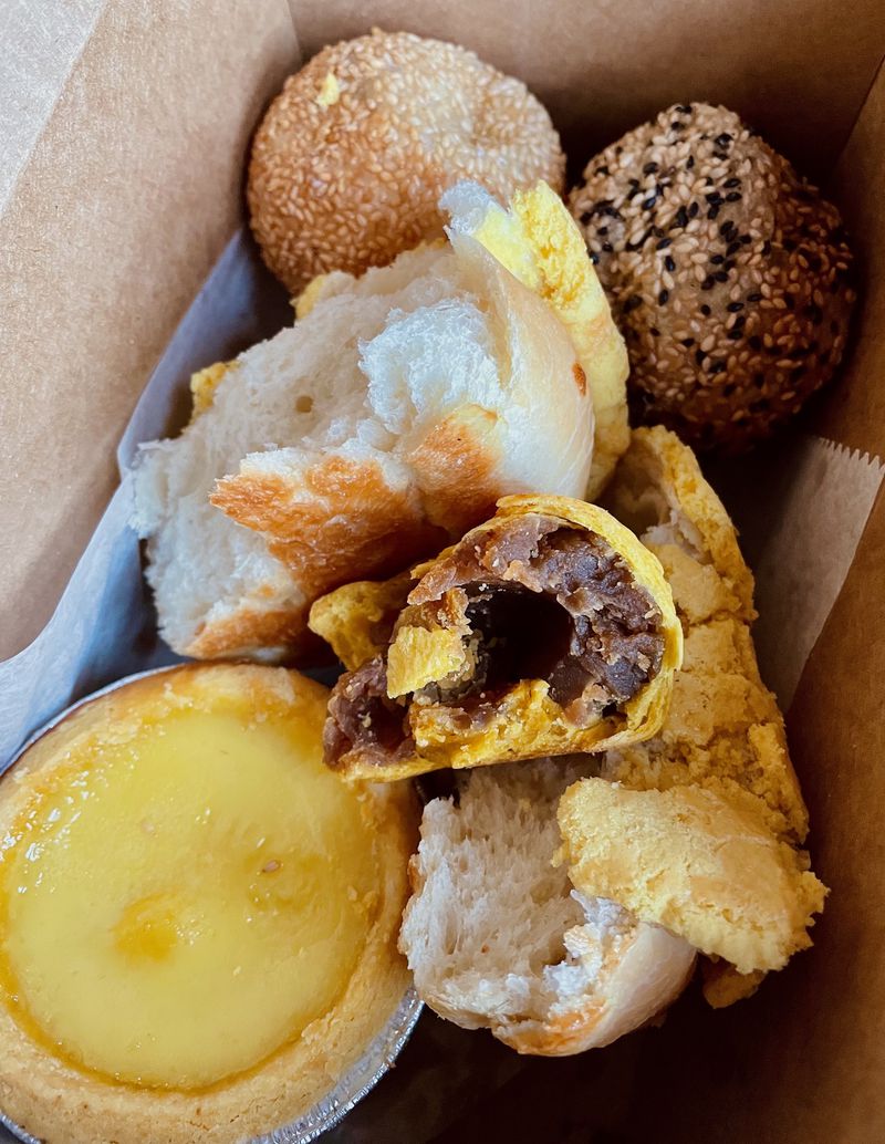 An assortment of Keefer Court pastries in a cardboard box.