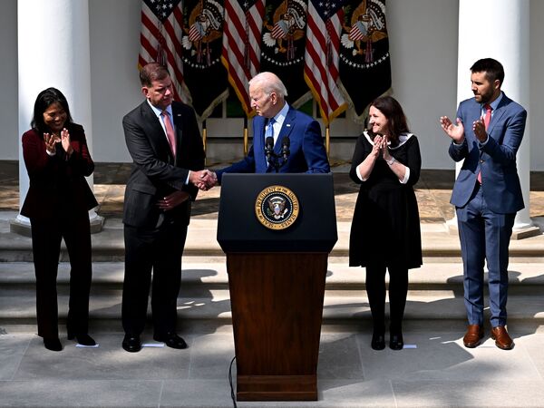 President Joe Biden shakes hands with U.S. Secretary of Labor Marty Walsh on September 15, 2022, after speaking about the railway labor agreement brokered by the White House. The deal has been ratified by eight of 12 rail unions.