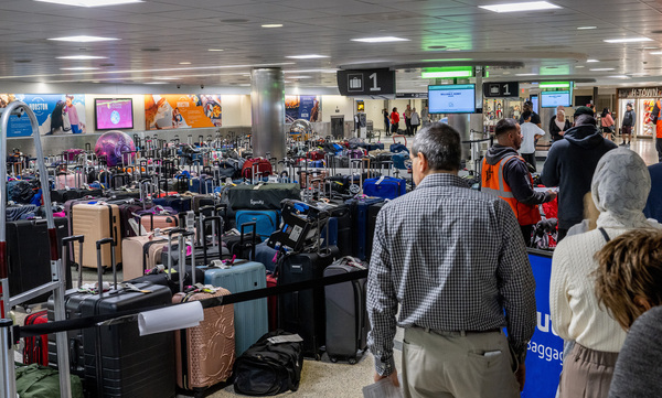 Travelers wait in line for help finding lost luggage at the William P. Hobby Airport on Dec. 28 in Houston, Texas.
