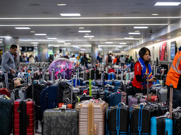 Airline staff searching through unclaimed luggage at the William P. Hobby Airport on Dec. 28 in Houston, Texas.