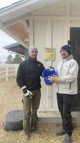 Ron Kern and his son Tony show off some of the eggs they've gathered outside of their chicken coop at Back Forty Farms in Nampa, Idaho.