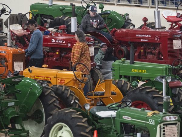 People view antique tractors at the annual Pennsylvania Farm Show in Harrisburg, Pa., Wednesday, Jan. 11, 2023.