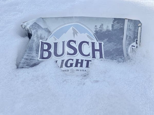 an abandoned beer box in snow