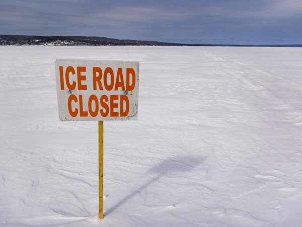 A sign warns travelers that the ice road is closed