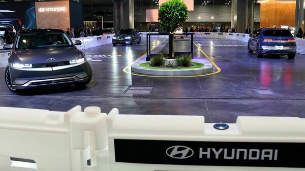 The Hyundai Ioniq 5 electric vehicle, shown driving inside a convention center at the 2022 New York International Auto Show, starts at around $40,000. Automakers are working to bring down the price of electric vehicles, which currently average $58,385. But in the meantime, they are not producing as many cheap gas-powered cars as they used to.