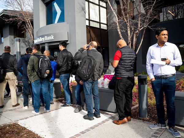 Silicon Valley Bank customers wait in line in Santa Clara, Calif. on March 13, 2023 after regulators took over the collapsed bank.
