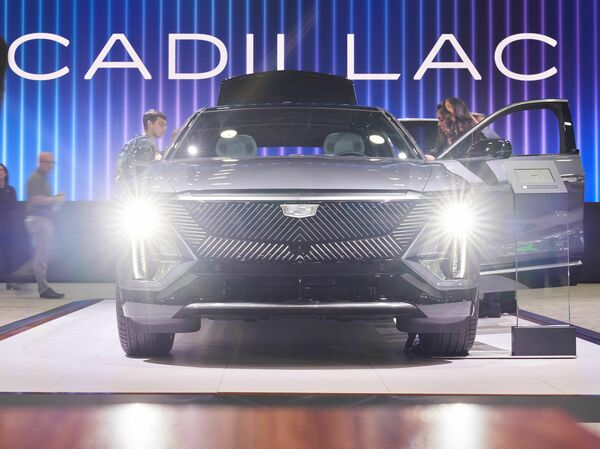 People look at the Cadillac Lyriq at the North American International Auto Show in Detroit on Sept. 14, 2022. The electric car should still qualify for the full tax credit under the latest IRS guidelines, according to General Motors.