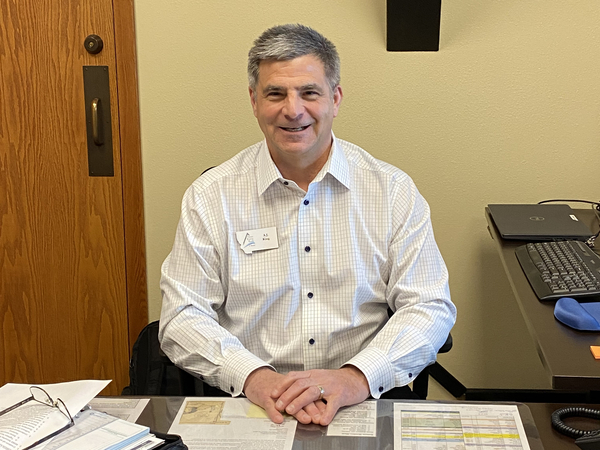 A.J. King, the CEO of Three Rivers Bank in Kalispell, Montana, sitting at his office. King says his bank shouldn't have to pay for mismanagement at Silicon Valley Bank and Signature Bank.