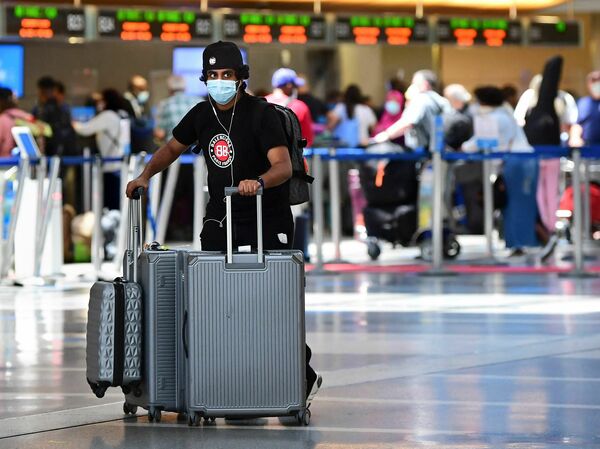 A man pushes his bags at Los Angeles International Airport (LAX) on May 27, 2021 in Los Angeles as people travel for Memorial Day weekend. The Department of Transportation has a website to assist travelers with knowing their rights.