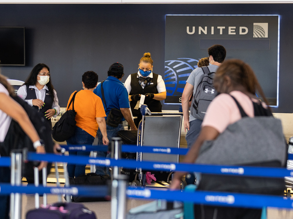 Travelers line up to check in for United Airlines flights at Newark Liberty International Airport on July 1, 2022 in Newark, N.J. Experts are predicting heavy travel this summer.