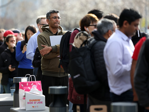 People line up outside of a Silicon Valley Bank office in Santa Clara, Calif., on March 13, 2023. Days after Silicon Valley Bank collapsed, customers lined up to try and retrieve their funds from the failed bank.