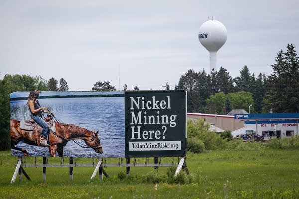 A large billboard with the words "Nickel Mining Here?"