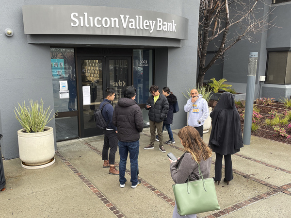 People line up outside the shuttered headquarters of Silicon Valley Bank in Santa Clara, Calif., on March 10. The bank's collapse sparked a period of intense volatility in markets. Although fears of a banking crisis have subsided, investors are still nervous about the health of smaller and regional lenders.